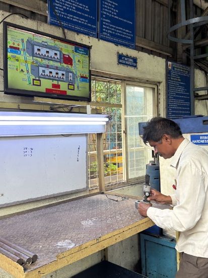 Technician checking parts beside the SCADA display