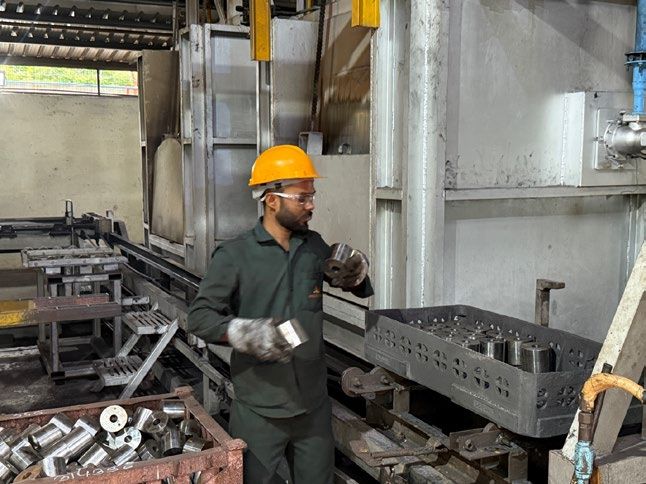 Operator loading forgings at the furnace line