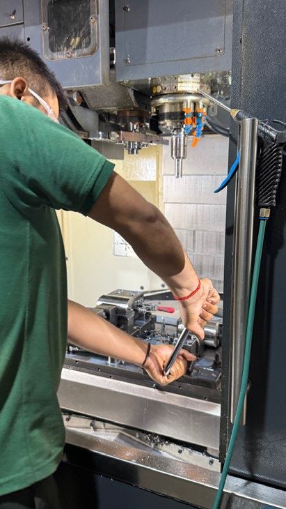 Operator setting up a workpiece on a VMC