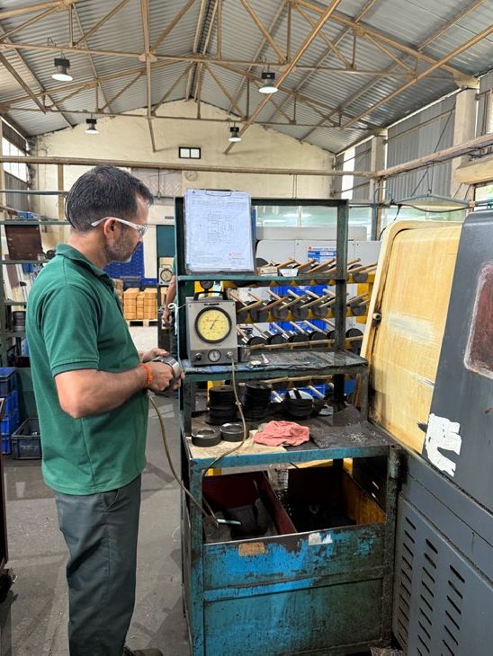 Operator gauging a part at a CNC lathe
